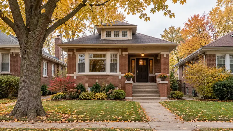 Chicago-style brick bungalow on a tree-lined street in autumn